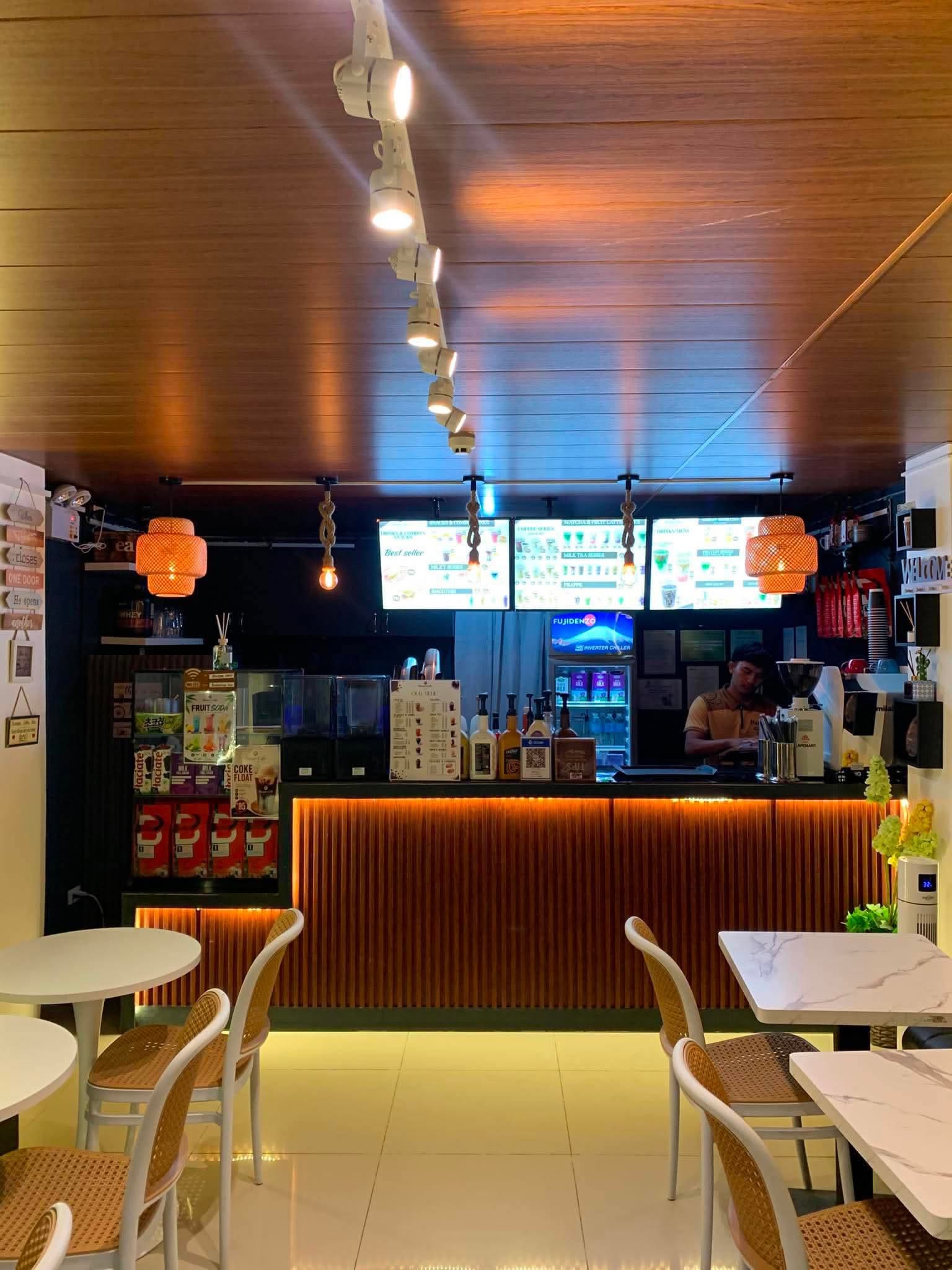 Warmly lit Busan Cafe counter with walnut wood details
